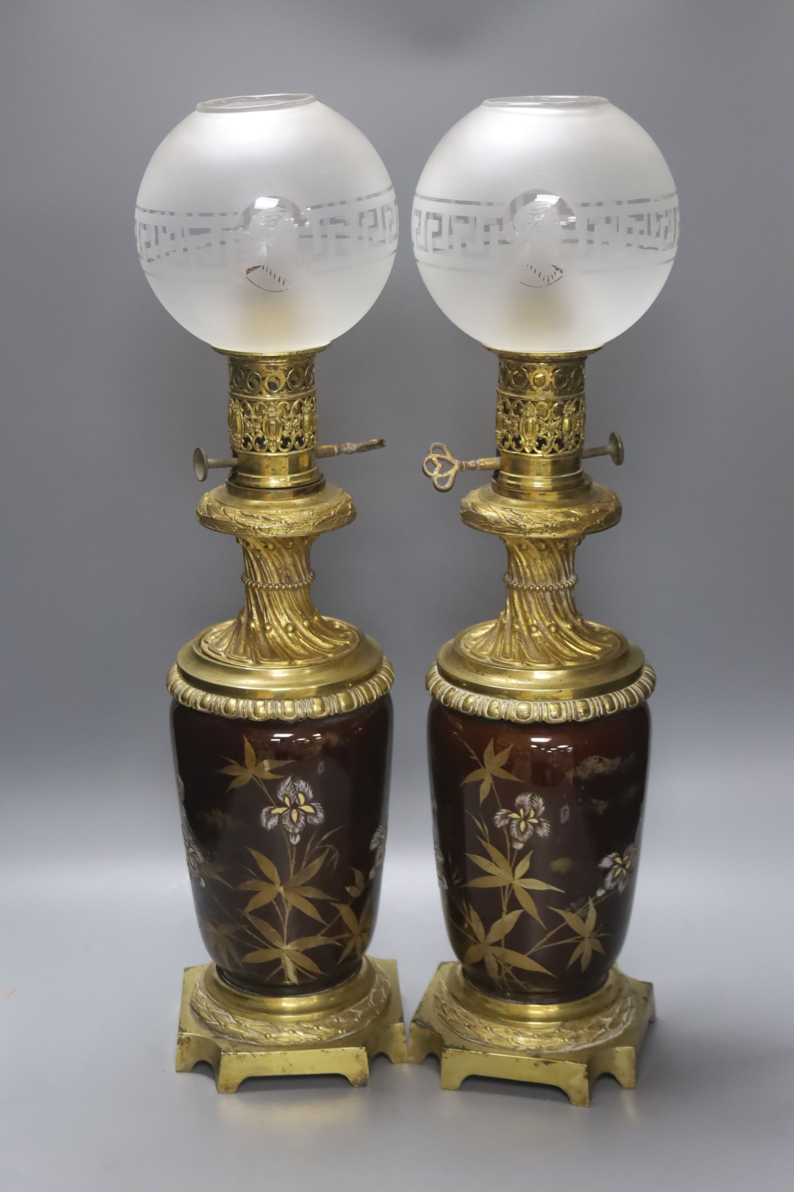 A pair of 19th century French ormolu and enamelled oil lamps, height 46cm